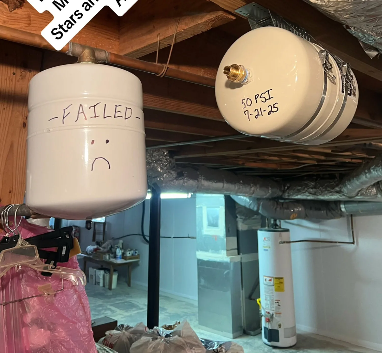 The waterlogged expansion tank we pulled, alongside its replacement.