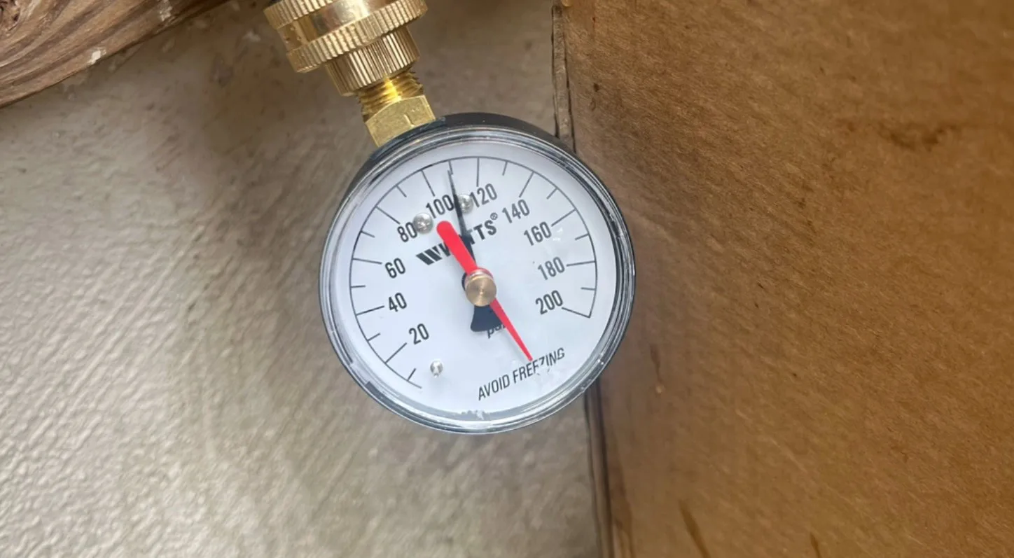 Before: the gauge reading well above the safe range for household plumbing.