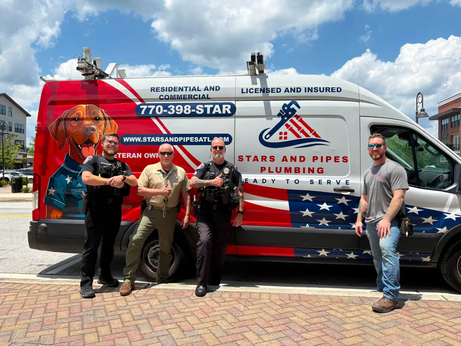 Stars and Pipes Plumbing Atlanta with City of Snellville Police Department officers in front of the company service van