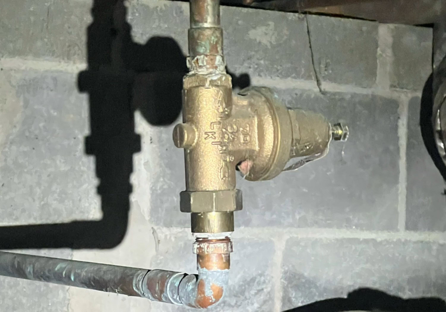 Old pressure reducing valve (PRV) in a home's crawl space