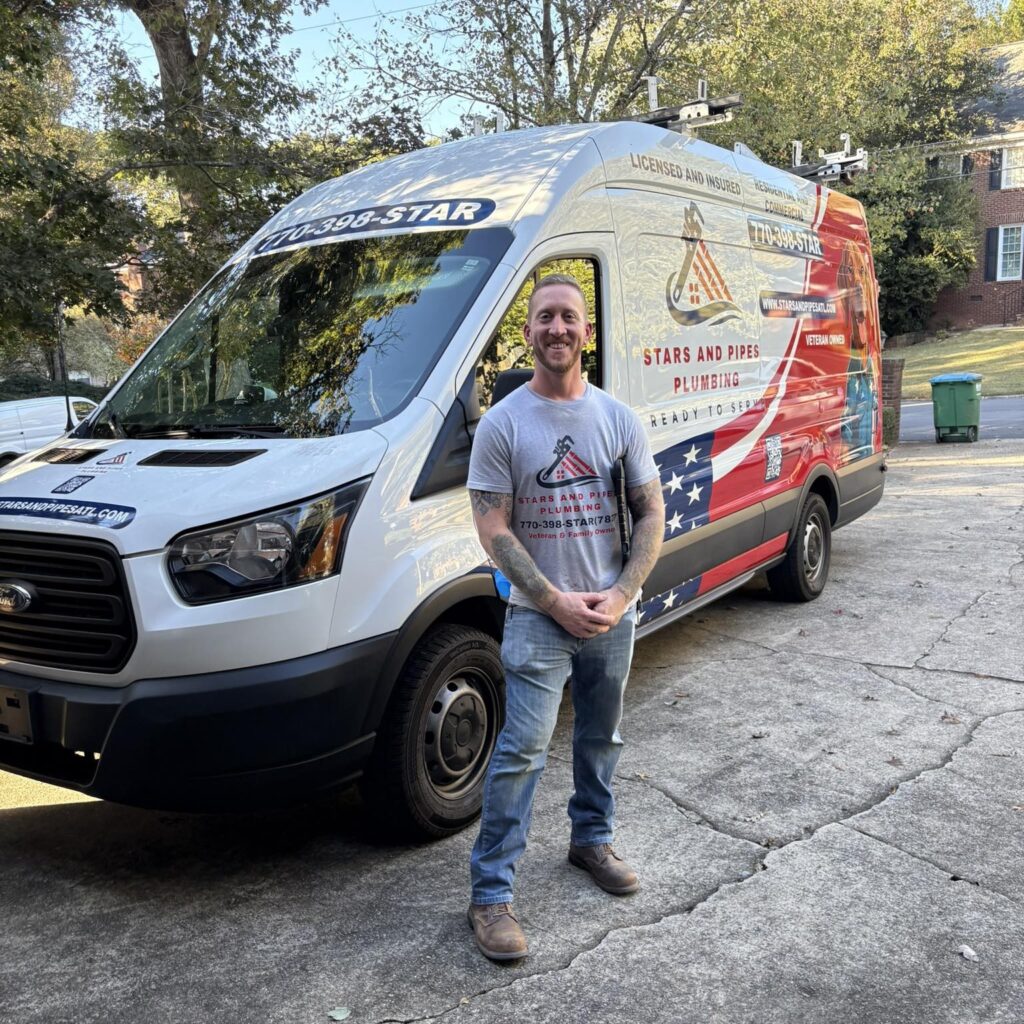 Professional plumber, Sean Nelson, Owner of Stars and Pipes Plumbing Atlanta with service van.